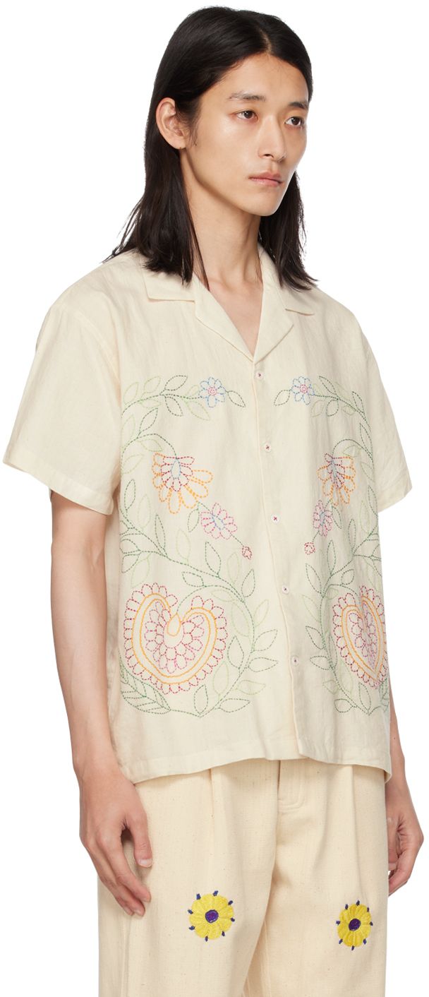 Handcrafted plain-woven cotton shirt. Floral graphics embroidered throughout. · Open spread collar · Button closure Supplier color: Off-white White Embroidered Camp Shirt For Spring, Spring Embroidered White Camp Shirt, White Camp Collar Top With Floral Embroidery, White Embroidered Shirt With Camp Collar, Embroidered Collared White Camp Shirt, Embroidered White Short Sleeve Camp Shirt, White Embroidered Collared Camp Shirt, White Embroidered Short Sleeve Camp Shirt, Cotton Camp Shirt With Embroidered Camp Collar