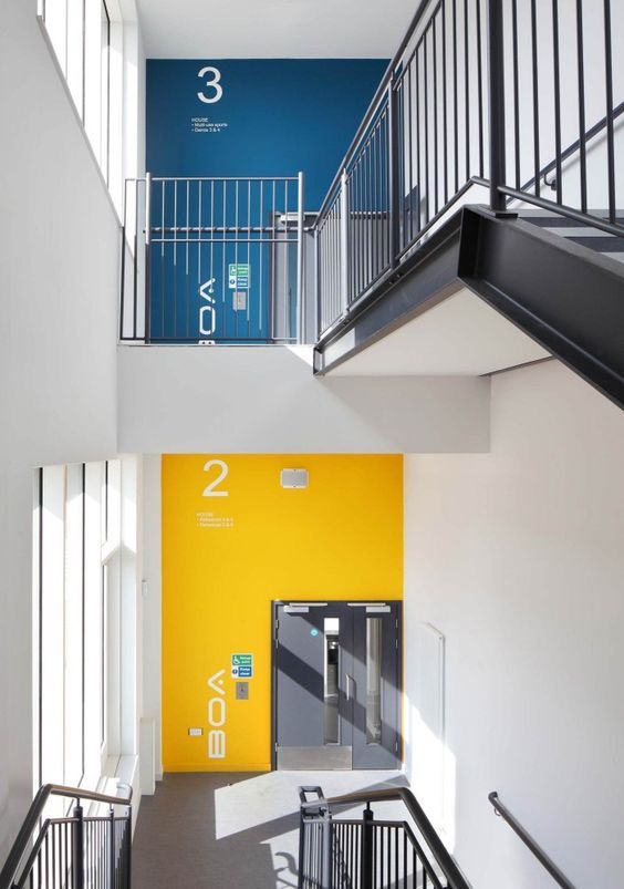 two staircases leading up to the second floor with yellow and blue paint on them