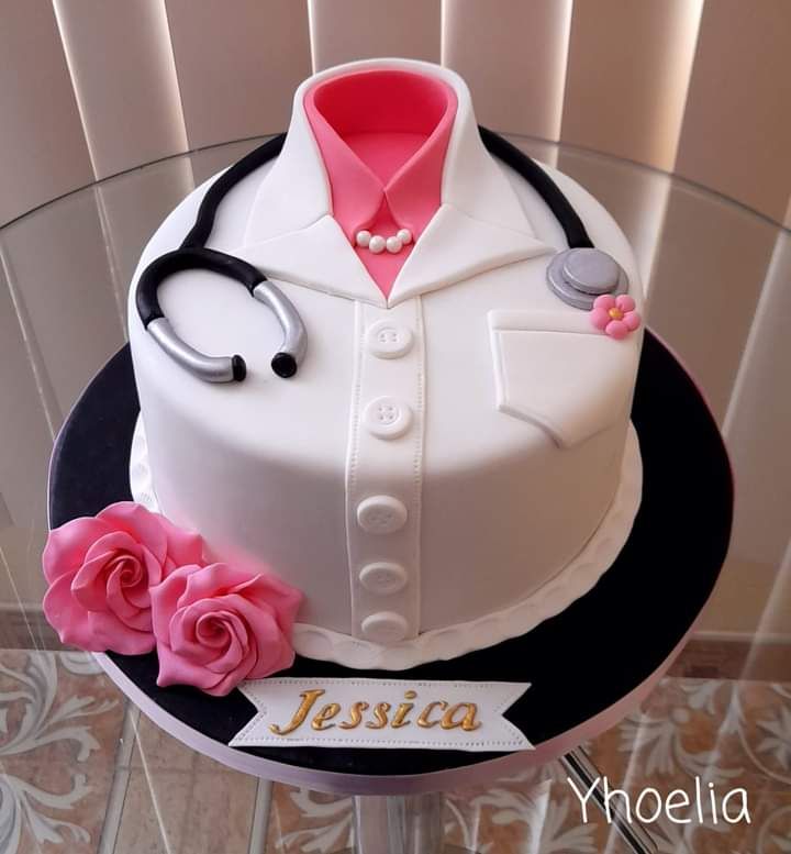 a cake decorated with a doctor's uniform and pink roses