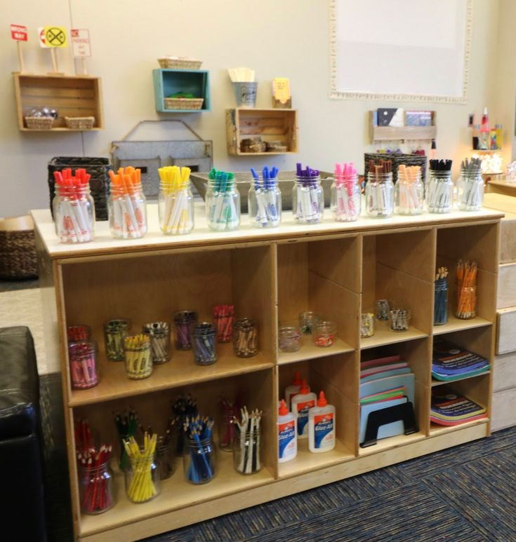 a room filled with lots of different types of pens and pencils on top of wooden shelves