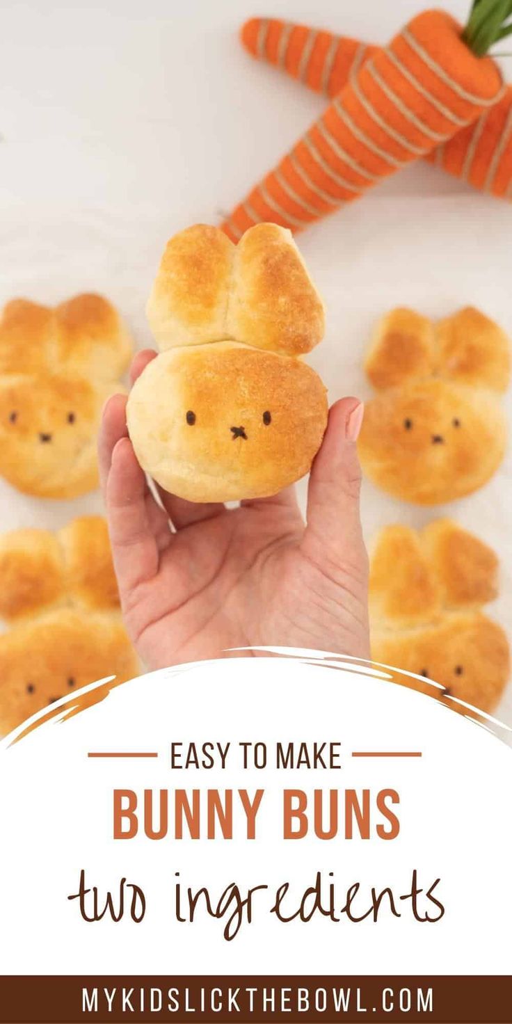 a person holding up a bunny buns with carrots in the background