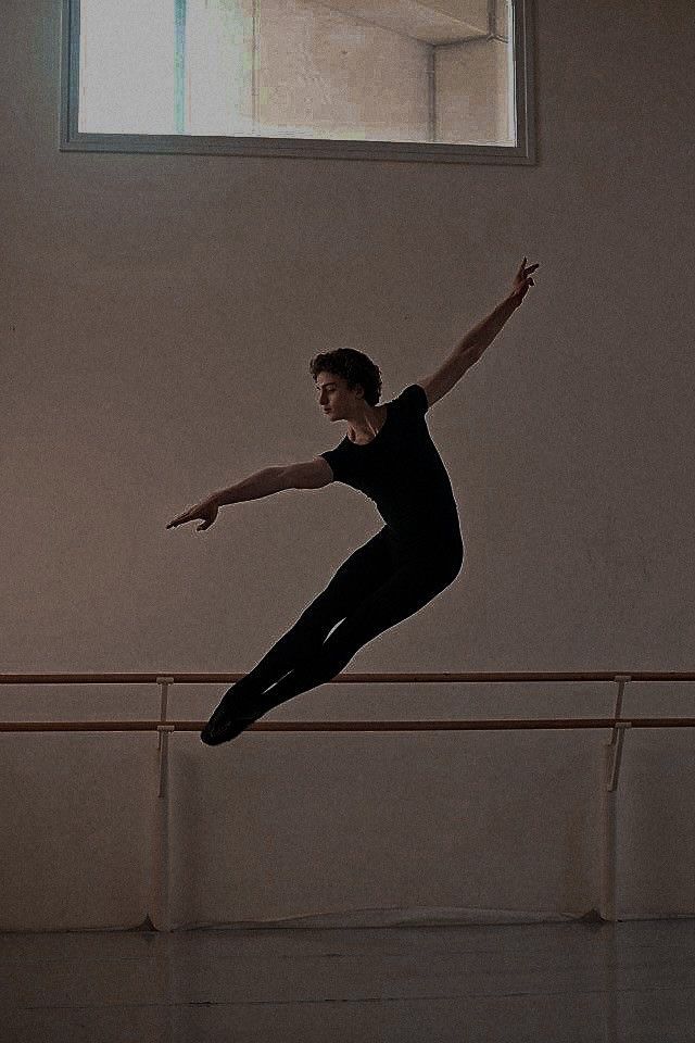 a young man is practicing his ballet moves