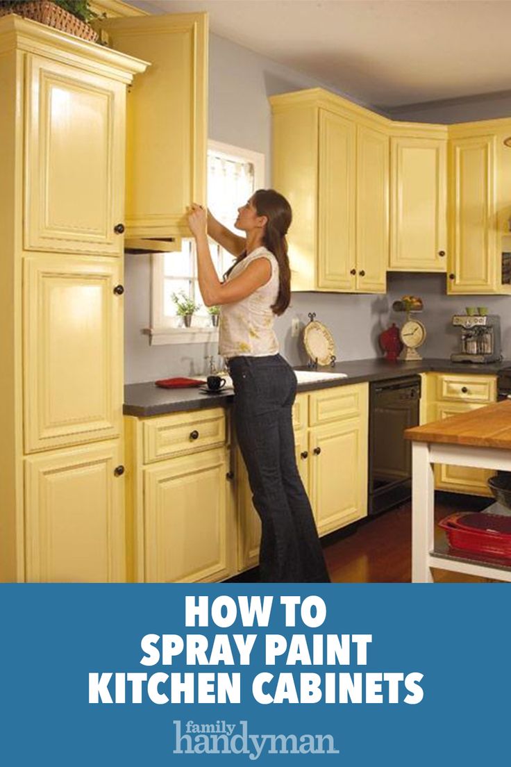 a woman is painting the cabinets in her kitchen with yellow and black paint on it