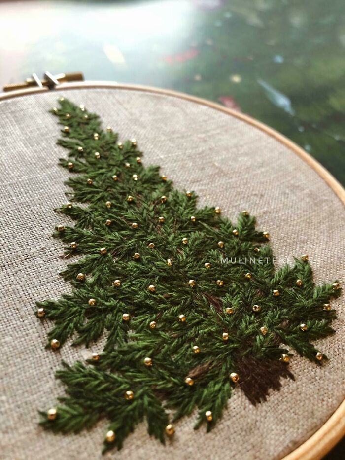 a close up of a cross stitch christmas tree ornament