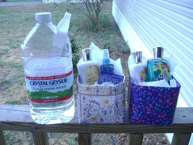 a bottle of water sitting on top of a wooden rail next to other bottles and containers