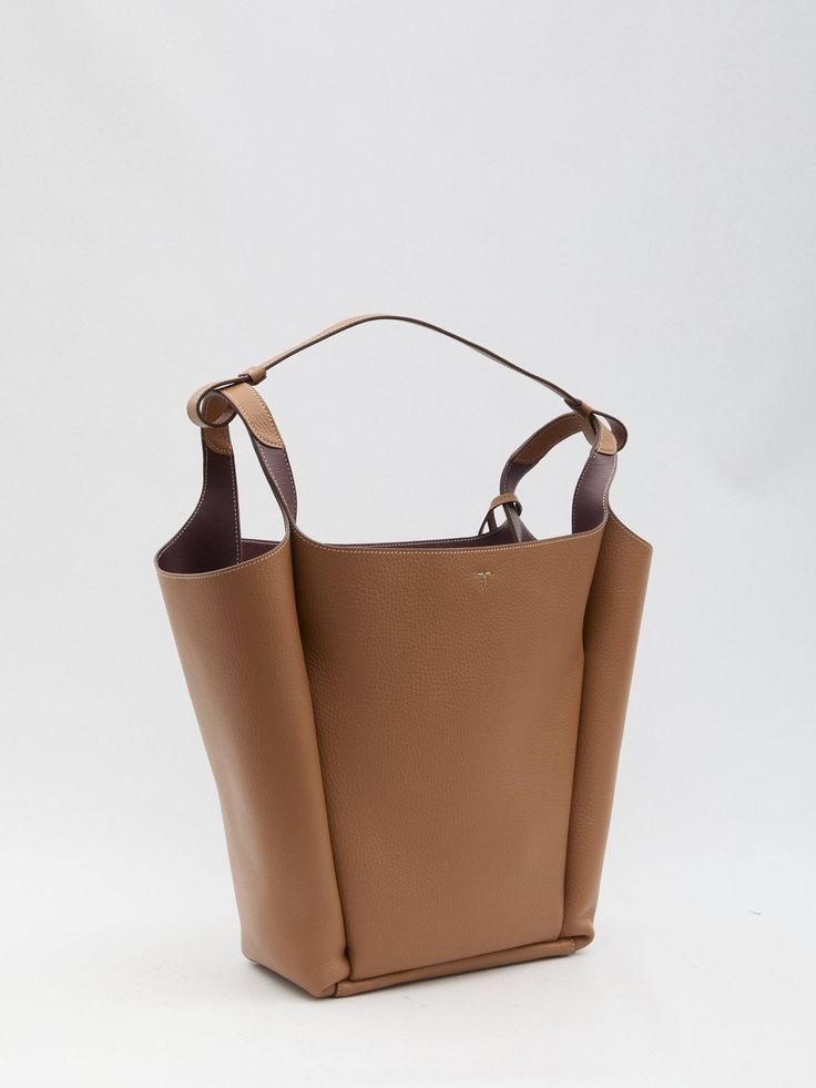 This medium bucket bag is made from brown and bordeaux grained calfskin and features Tod's logo embossed on the front. It includes a detachable T Timeless detail in metal, a flat handle, a hook closure, one main interior compartment, and two interior pockets. Any imperfections in the leather should not be seen as manufacturing defects, but rather as a characteristic of the material.    Dimensions: 16.5x12.9x5 inches  Bucket bag  Grained leather  Detachable T Timeless detail  Hook closure  Produc Textured Calf Leather Bucket Bag, Classic Brown Calf Leather Bucket Bag, Luxury Brown Bucket Bag For Office, Brown Calf Leather Top Handle Bucket Bag, Brown Calf Leather Bucket Bag With Handle Drop, Designer Brown Bucket Bag With Double Handle, Calf Leather Bucket Bag With Smooth Grain, Modern Cognac Bucket Bag With Removable Pouch, Designer Brown Double Handle Bucket Bag