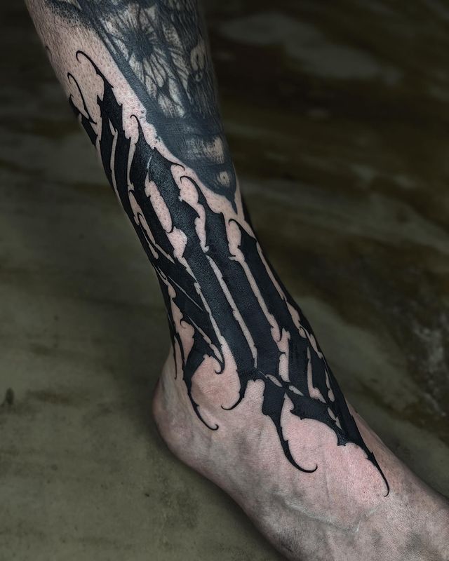 a man's foot with a tattoo design on it