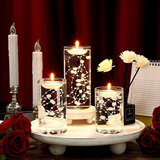 candles and flowers are arranged on a tray