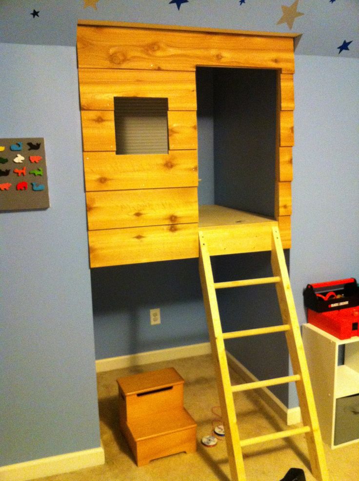 a loft bed with a ladder to the top and storage space below it in a child's bedroom