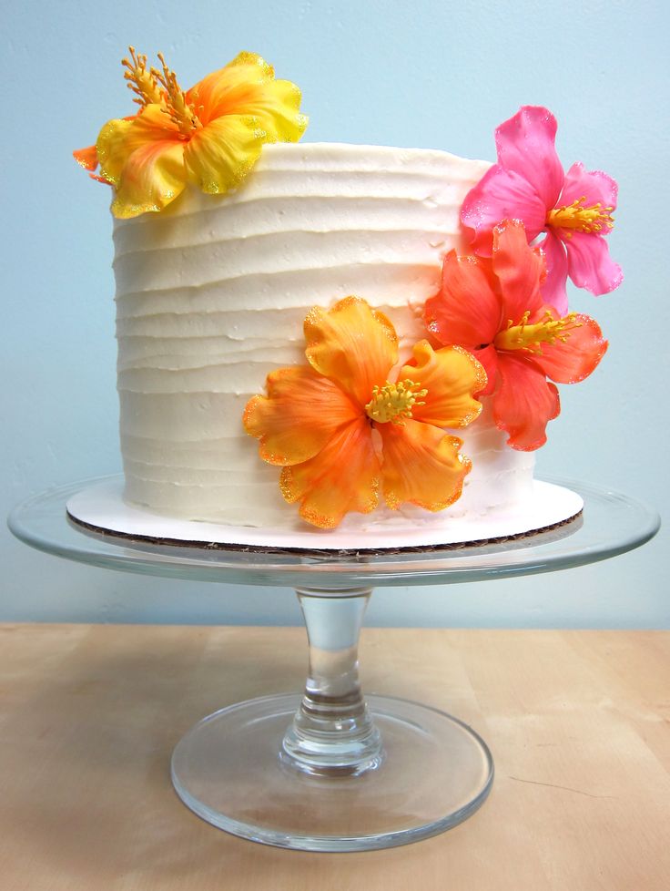 a white cake with orange and yellow flowers on top