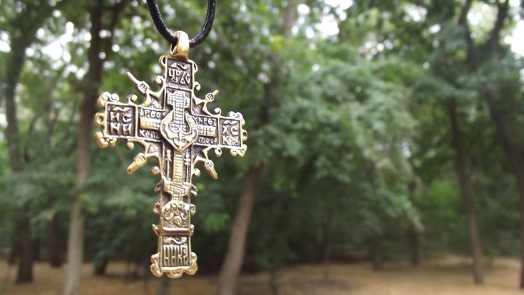 "A copy of the historical findings. The Cossack cross. 16-18 century Description: Double-sided pendant Metal: bronze or silver 925 Weight: approx. 9 g Size: approx. 5,5 x 3,4 cm \\ 2,16\" x 1,33\" Hole size: 2 mm \\ 0,07'' The product will be shipped complete with a cotton cord black color. *The color of real item may be a little different from the pictures due to the display of screen. Bronze - metal, which over time can oxidize and darken on the air. All my creations are intentionally patinate Medieval Engraved Cross Pendant Jewelry, Ceremonial Cross Necklace In Spiritual Style, Traditional Cross Necklace With Large Pendant, Bronze Cross Pendant Necklace For Gift, Handmade Medieval Cross Jewelry, Handmade Brass Cross Pendant Necklace, Bronze Cross Spiritual Jewelry, Spiritual Bronze Cross Jewelry, Medieval Engraved Cross Jewelry