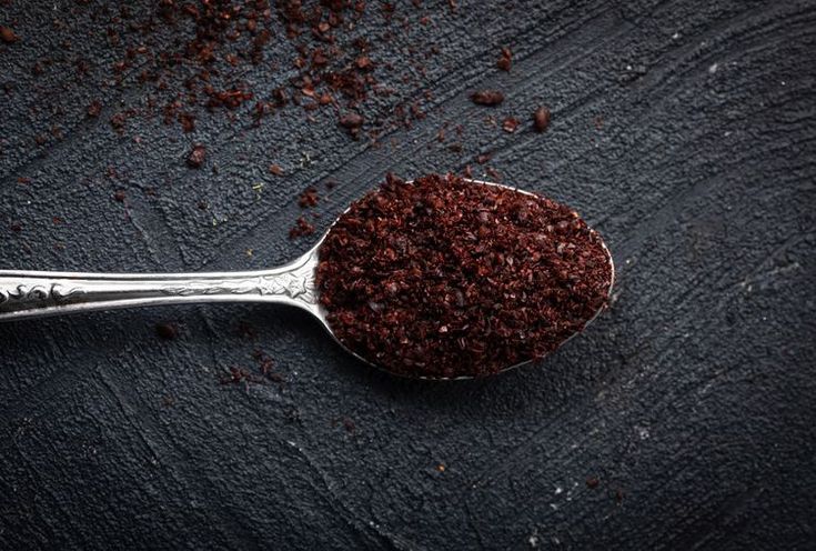 a spoon filled with brown sugar on top of a table