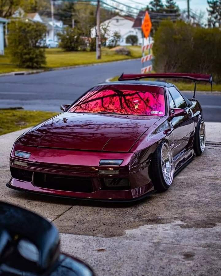 a red sports car parked in front of a house