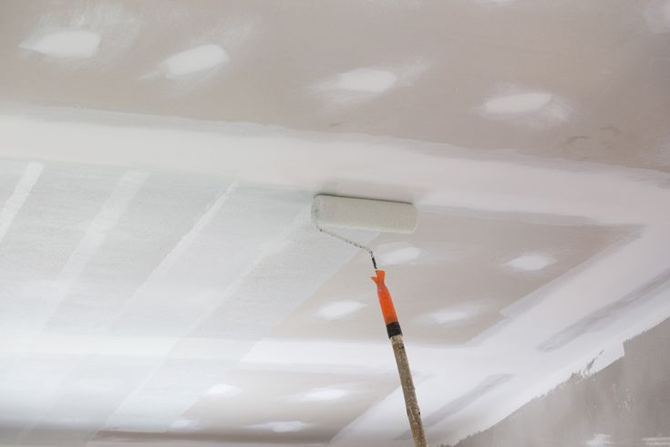 a paint roller is being used to paint the ceiling