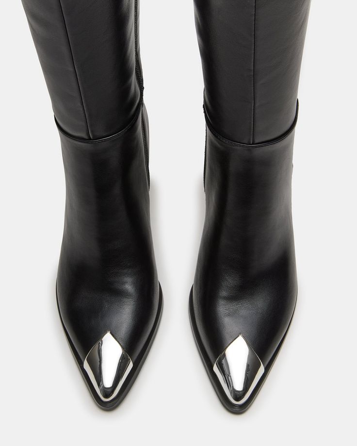 The LUCIANA is a stylish and sophisticated knee-high boot with a sleek kitten heel and pointed toe. Its silver toe cap adds a touch of elegance to any outfit. Expertly crafted for comfort, these boots are perfect for any occasion. 2.25 inch heel height Size 6 measurements: 14 inch shaft circumference, 15.25 inch shaft height Size 8 measurements: 15 inch shaft circumference, 16.25 inch shaft height Size 10 measurements: 16 inch shaft circumference, 17.25 inch shaft height Vegan leather upper mate Elegant Silver Knee-high Boots, Elegant Silver Heeled Boots For Fall, Silver Pointed Toe Heeled Boots For Fall, Silver Knee-high Boots With Pointed Toe For Fall, Trendy Silver Pointed Toe Heeled Boots, Leather Socks, Black Knees, Spring Tops, Spring Looks