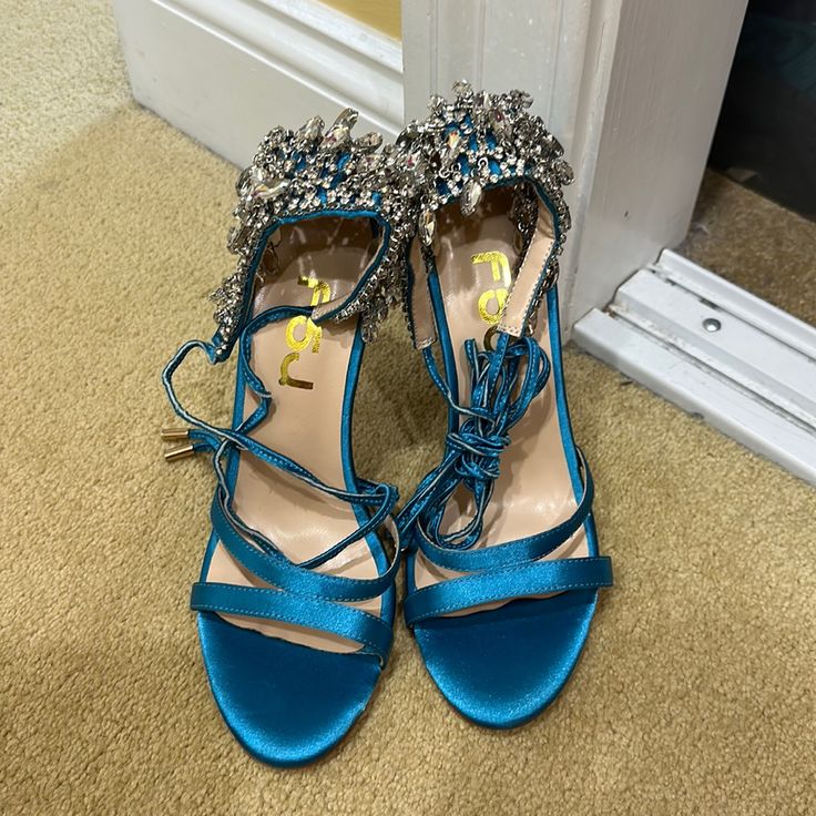 Gorgeous Rhinestone Tie Up Bright Blue Heels Size 8. Never Worn Glamorous Blue Sandals For Wedding, Chic Blue Heels For Prom, Glamorous Light Blue Heels For Party, Glamorous Blue Party Sandals, Blue Heels With Rhinestones And Round Toe, Chic Turquoise Heels For Evening, Blue Rhinestone Round Toe Sandals, Turquoise Heels For Party, Green Rhinestone Round Toe Heels