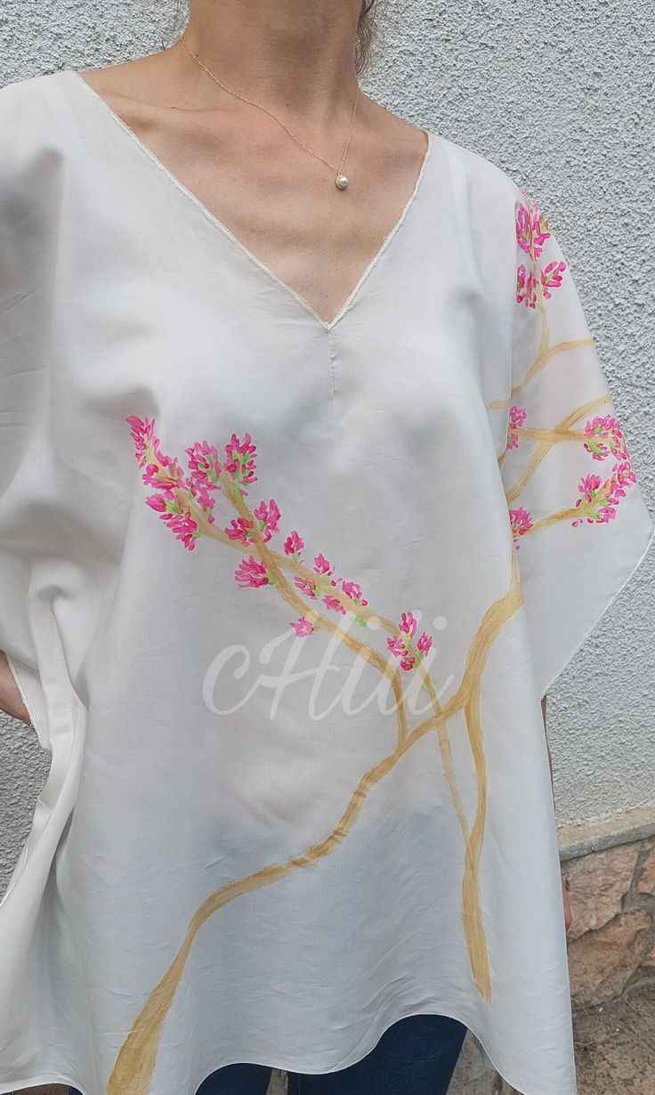 Limited, unique, hand painted silk-viscose tunic with pink Bougainvillea. You will be special wearing this clothes. The item made of silk-viscose fabric, it is pleasant to wear in the summer heat. Hand painted and sewing by me.  Dry-cleanable or handwash only and please don't tumble dry! Handmade item. There is a seam on both side. You can see in the last picture all windths and lengths. The whole length is 70 cm. If you have any questions, please contact me. https://www.instagram.com/p/C8oW6O3o Spring Silk Kaftan With Floral Embroidery, Silk Kaftan With Floral Embroidery For Spring, Casual Silk Kaftan For Spring, Summer Silk Tunic With Floral Print, Summer Kaftan With Floral Embroidery And Kimono Sleeves, Silk V-neck Tunic For Summer, White Hand Painted Top For Summer, Silk Summer Tops With Floral Embroidery, Spring Silk Tunic