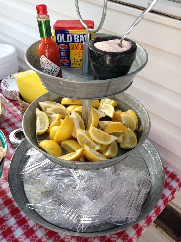 three tiered trays filled with food and condiments