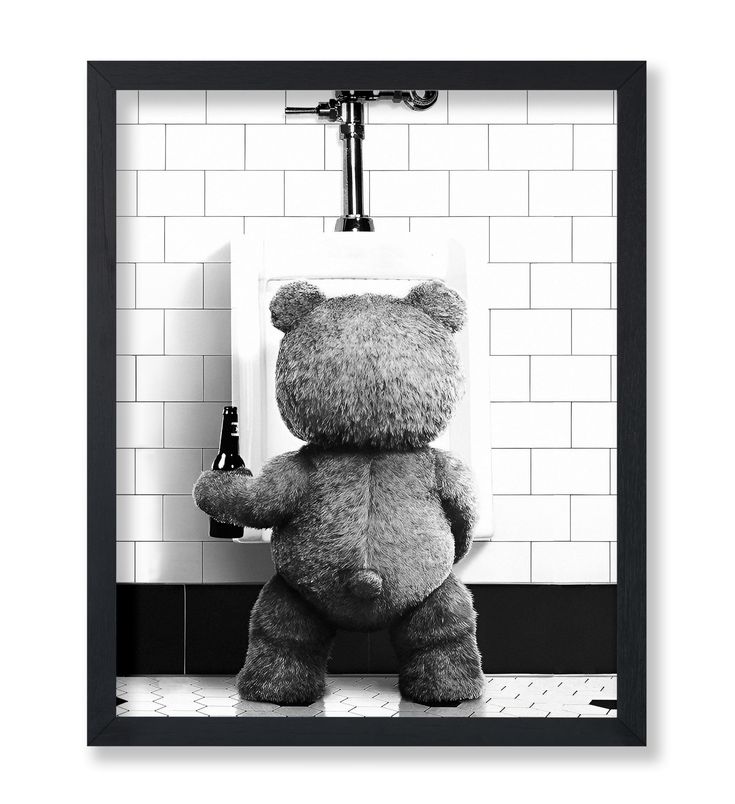 a black and white photo of a teddy bear holding a beer in front of a urinal