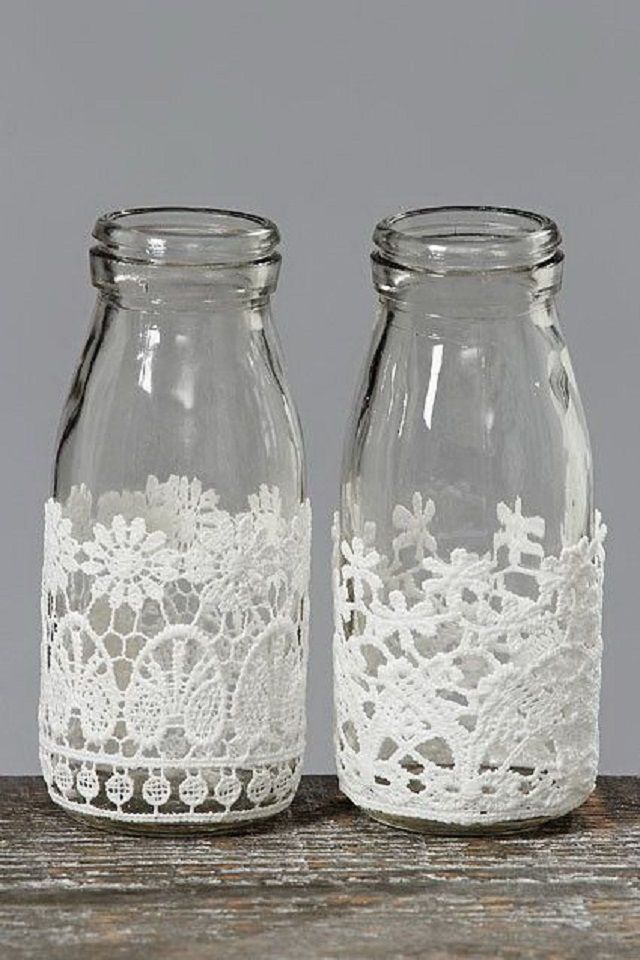 two glass jars with white lace on them