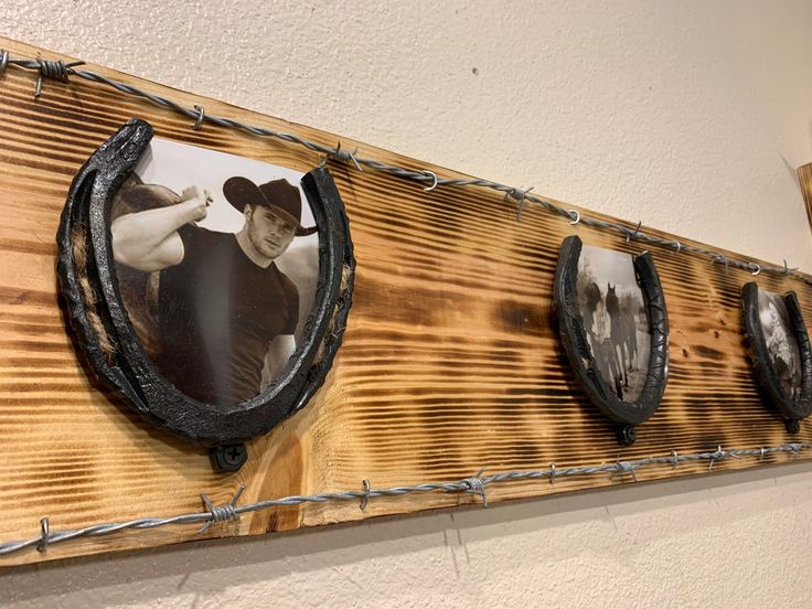 three pictures hanging on a wooden wall with barbed wire around them and an image of a man