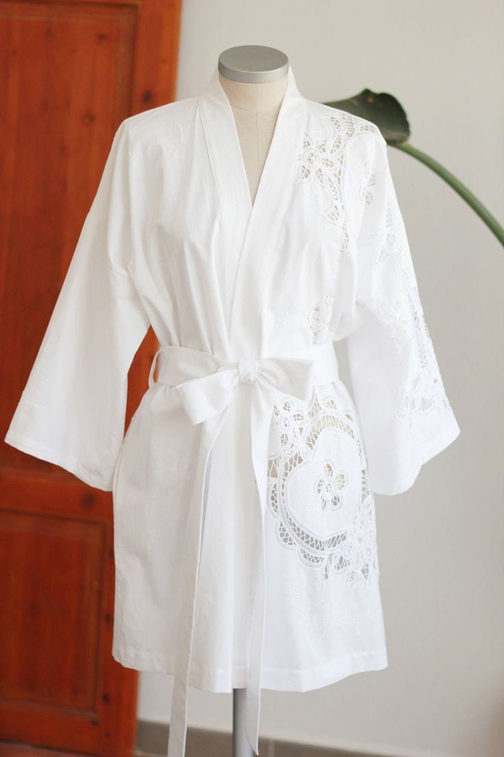 Caroline is a luxurious wrap robe with a relaxed fit made from a vintage Battenberg textile hemmed above the knee with side seam pockets. - SKU: C01S01 - Designed & handmade in Spain - 100% Cotton - Size Small - Hand or machine wash gentle, lay flat to dry - Every textile carries the imprints of its journey through time. All signs of wear, character, stains and mending are reminders of its' history, and original to every carefully curated and preserved textile. White Relaxed Fit Daywear Robe, Robe With Relaxed Fit And Kimono Sleeves For Daywear, Elegant Cotton Robe For Daywear, Elegant Fitted Cotton Robe, Elegant Cotton Daywear Robe, Spring Open Front Home Robe, White Open Front Cotton Kimono, Fitted Cotton Robe For Daywear, White Cotton Open Front Kimono