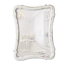 an ornate white mirror with beading around the edges