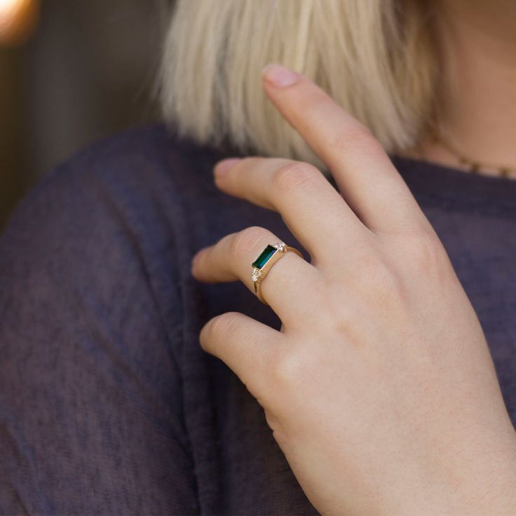 "Handmade by an inspired jewelry artist team with decades of experience in the craft of jewelry making. Each gemstone, each diamond is carefully picked. Using only the finest raw materials and the highest industry standard in manufacturing, design and finish. Sleek and sophisticated baguette Emerald and diamond ring. This rings dainty nature adds to its charm, the green emerald is set to show its depth and magnificent colors through out. The emerald is highlight perfectly with six round diamonds Everyday 14k Gold Gemstone Rings, Modern Diamond Ring For May Birthstone, Modern May Birthstone Diamond Ring, Everyday Rings With Gemstone And Recycled Gold, Everyday Gemstone Rings In Recycled Gold, Modern Emerald Rings With Baguette Cut, Modern Baguette Cut Birthstone Promise Ring, Modern 14k Gold Emerald Cut Birthstone Ring, Emerald Cut Bezel Setting Rings For Everyday