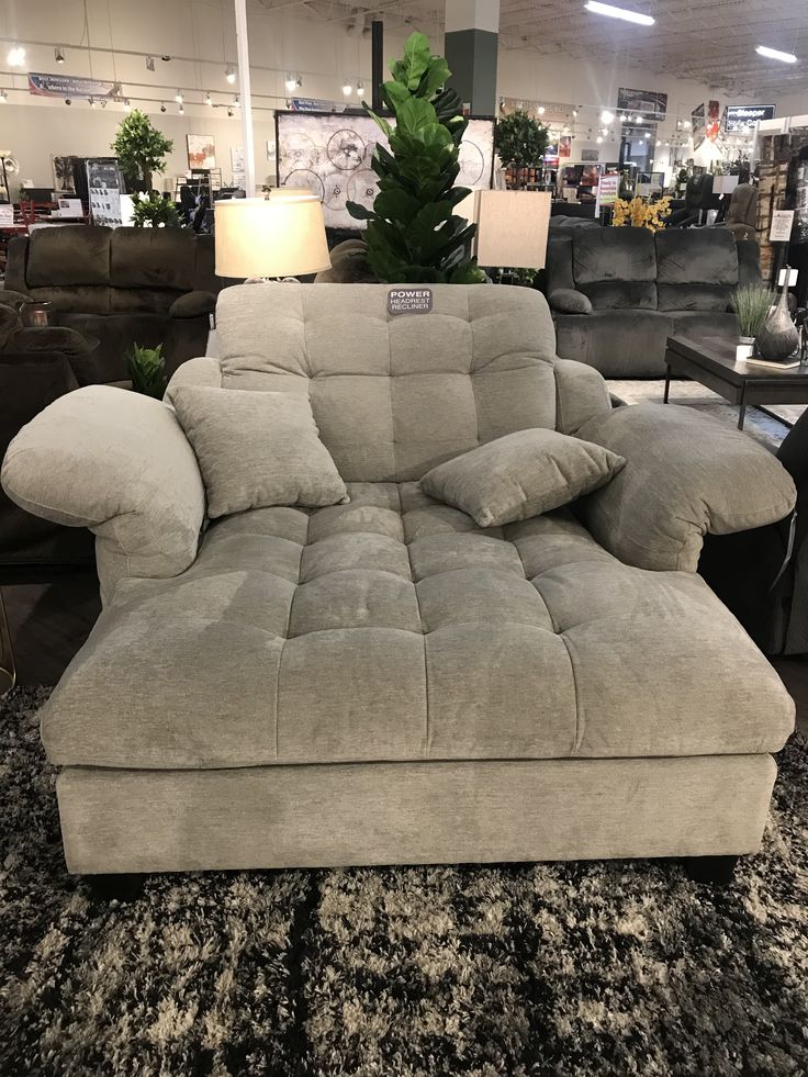 a couch with pillows on it in a store