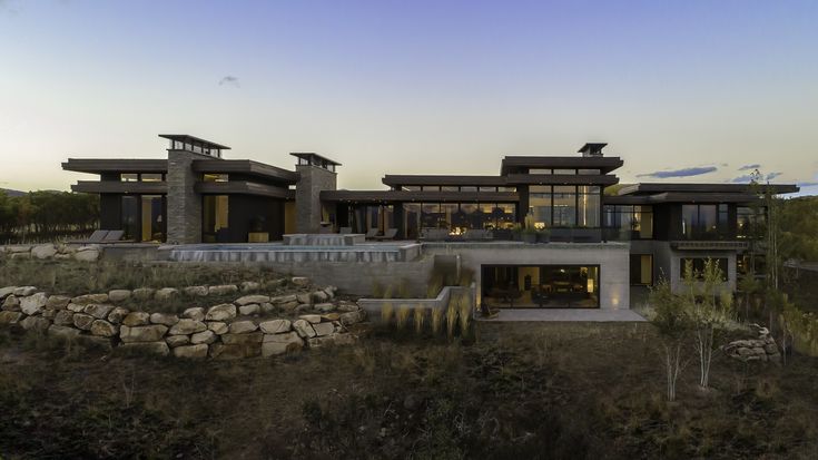 a large modern house in the middle of a field