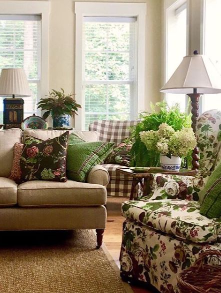 a living room filled with lots of furniture and pillows on top of it's couches