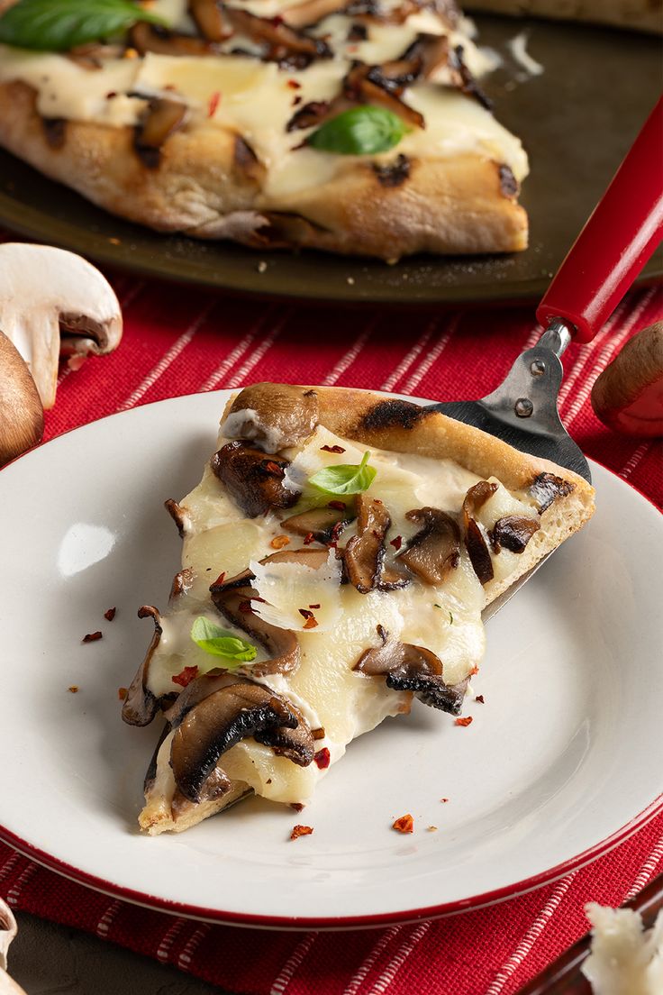 a slice of mushroom and cheese pizza on a plate