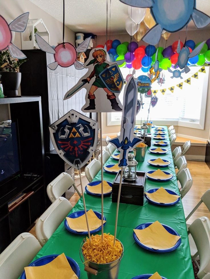 a party table set up with blue and yellow plates