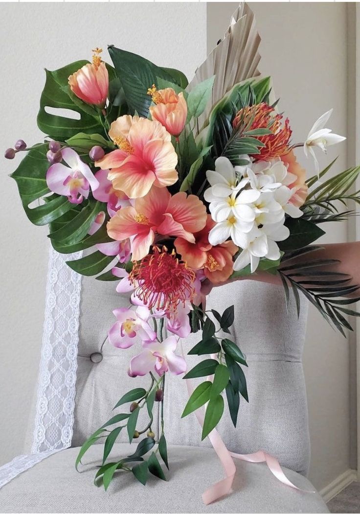 a bouquet of flowers sitting on top of a chair