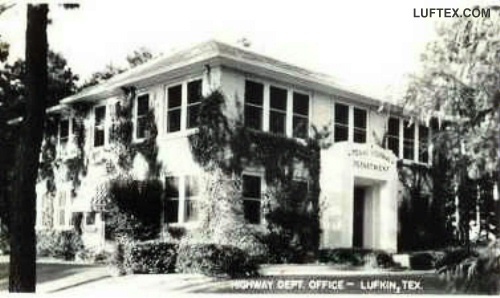 an old black and white photo of a building with ivy growing on it's sides