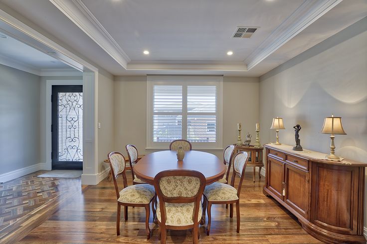 a dining room table and chairs in front of a window