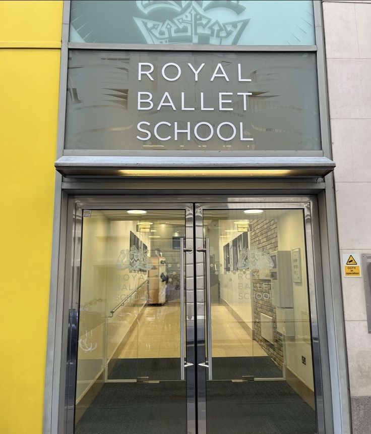 the entrance to royal ballet school with its glass doors and logo on the front door