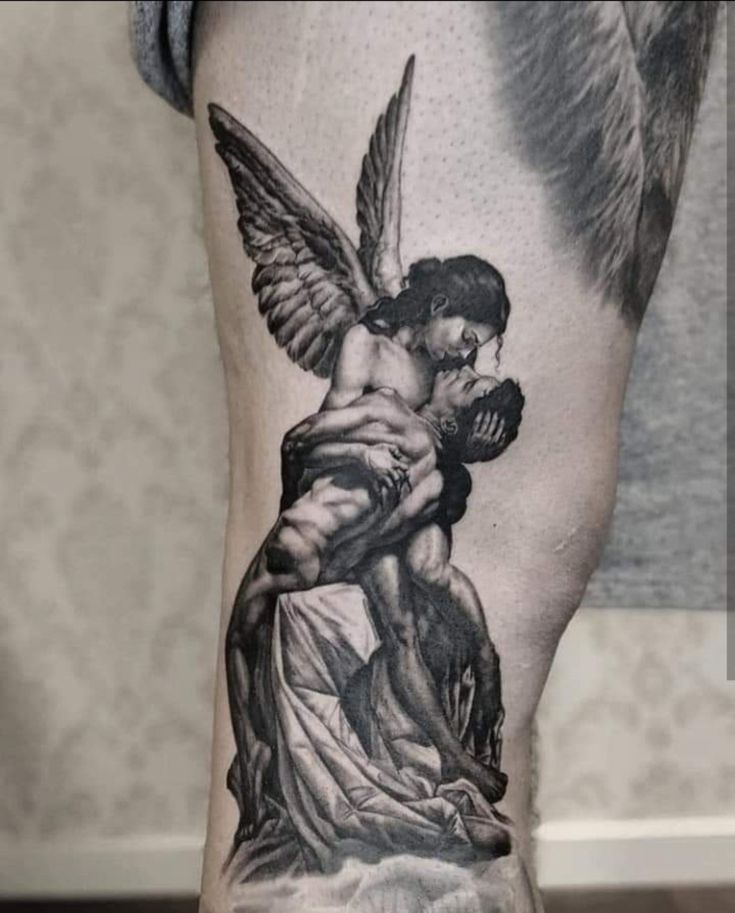 a man with an angel tattoo on his arm