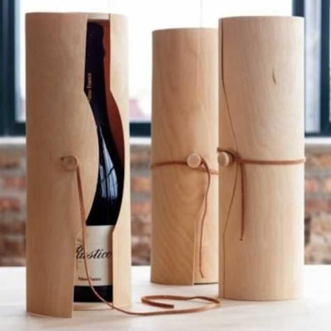 three wine bottles are wrapped in brown paper