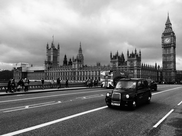 a black and white photo of the big ben clock tower towering over london, england