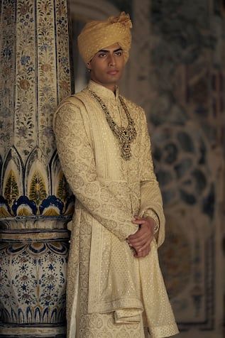 Gold sherwani featuring all-over tonal resham, beads and dabka embroidery. Paired with a solid kurta and coordinating churidar., Fit: Relaxed Naqshi Embroidered Straight Sherwani For Reception, Naqshi Embroidered Straight Kurta Sherwani For Reception, Naqshi Embroidered Sherwani For Reception, Ceremonial Churidar With Naqshi Straight Kurta, Semi-stitched Naqshi Traditional Wear For Reception, Traditional Naqshi Kurta For Reception, Traditional Fit Sherwani With Zari Work For Eid, Eid Sherwani With Zari Work And Traditional Fit, Eid Sherwani With Zari Work In Traditional Fit