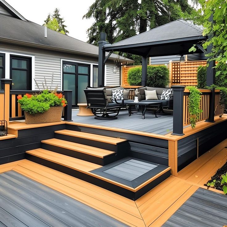 an outdoor deck with steps and planters on it