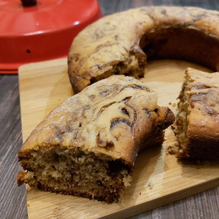 a wooden cutting board topped with a sliced cake