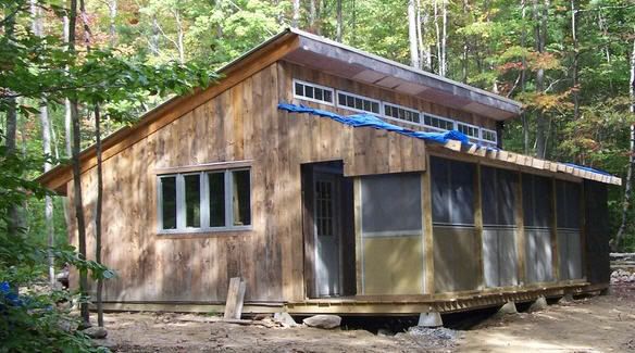 a small wooden cabin in the woods