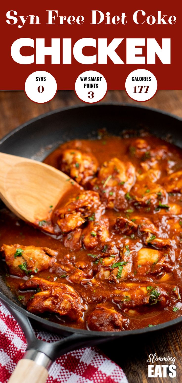 a skillet filled with chicken and sauce on top of a wooden table