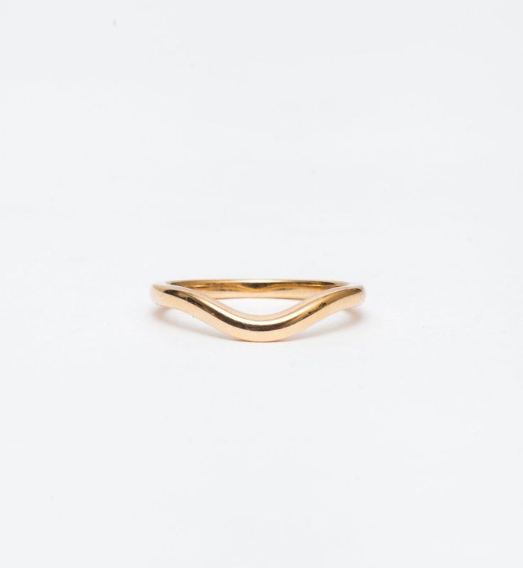 Simple and elegant, the polished form of this curved gold band makes a perfect complement to all of Single Stone's signature engagement rings. The gentle contour delicately traces around solitaires, halos, and geometric settings alike. You can even wear it in multiples or as a matched pair for even more stacking options. Made in the U.S.A. Measures 2.0 mm wide. Also available in DIAMOND. All sizes available by special order in 4-6 weeks. To inquire, including requests for alternate metal options