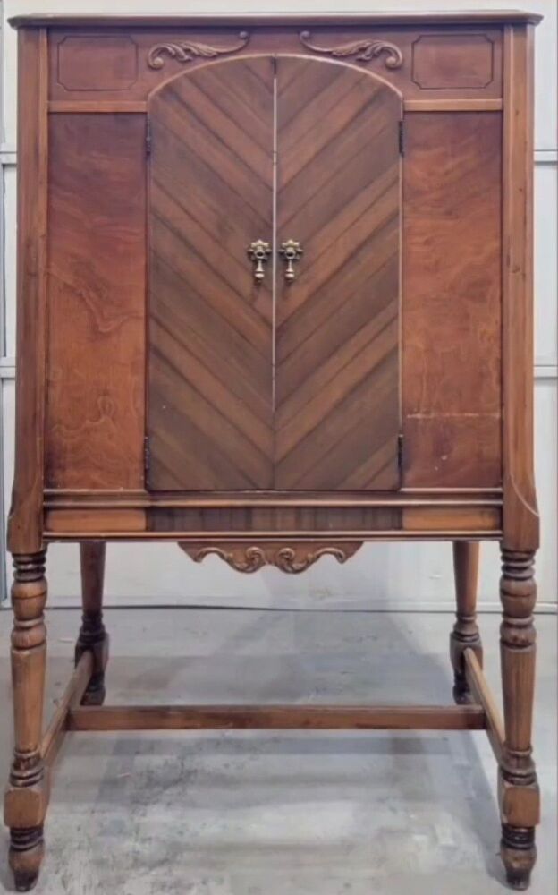 an old fashioned wooden cabinet with two doors