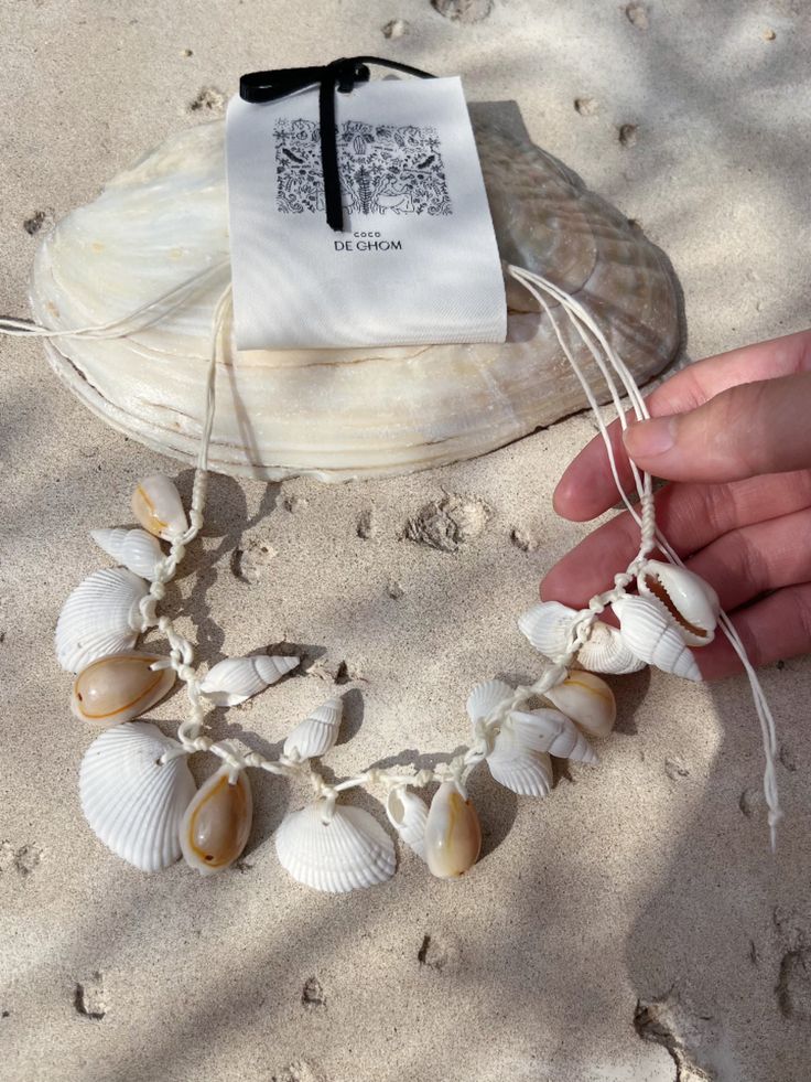 Embrace the essence of the ocean with our Boho Seashell Choker Necklace—an exquisite accessory for beach lovers and free spirits alike. Perfect for your next beach vacation, a seaside wedding, or simply adding a touch of coastal charm to your everyday look, this necklace captures the beauty of the sea in a minimalist, boho-inspired design. Handcrafted with natural seashells, each choker is a unique piece of ocean treasure that resonates with the tranquil vibes of the beach. Its simple yet elegan Ocean-inspired Shell Necklace Gift, Ocean-inspired Necklaces For Summer Gifts, Ocean-inspired Necklaces As Summer Gifts, Adjustable Ocean-inspired Shell For Beach Season, Adjustable Coastal Style Shell Strand, Ocean-inspired Jewelry For Vacation, Handmade Ocean Color Necklaces For Beach, Handmade White Beach Jewelry, Handmade Ocean-colored Strand Jewelry