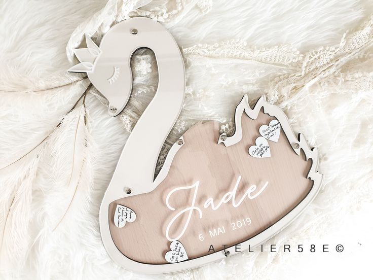 a personalized wooden ornament for a baby's first birthday with hearts