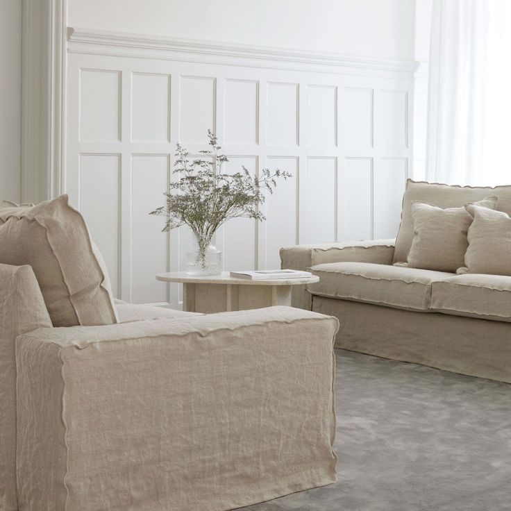 a living room filled with furniture and white walls